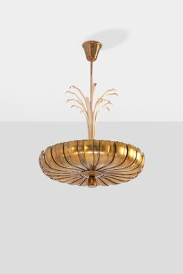 a gold plated chandelier with a glass bowl hanging from the ceiling