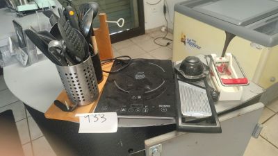 a stove top with a bunch of utensils on top of it