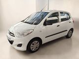 a picture of a small white car parked in a garage
