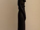 a statue of a woman holding a vase on top of her head