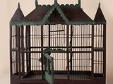 a small bird cage with a bird inside of it