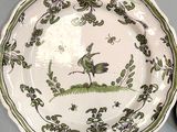 a plate with a bird on it sitting on a table