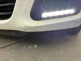 a close up of a car ' s front bumper with a light on