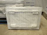 a box of toilet paper sitting on the floor in a warehouse