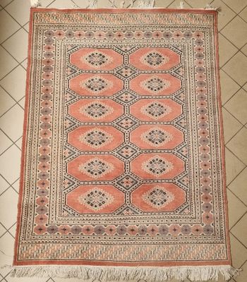 un tapis orange et noir posé sur un sol carrelé