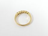 a close up of a gold ring on a white surface