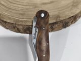 a knife that is sitting on top of a piece of wood