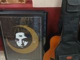 a guitar, a guitar case, and a picture on the floor