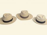 three hats sitting on top of each other on a white surface