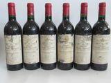 six bottles of red wine lined up in a row