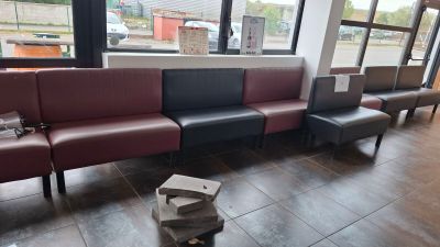 a couch that is sitting in a room with a lot of windows