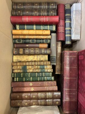 an open box filled with lots of old books sitting on top of a table