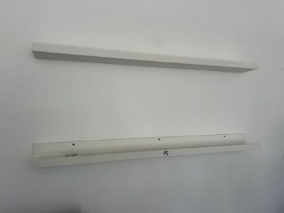 a white shelf that has two white shelves on it