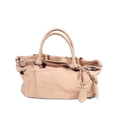 an image of a beige handbag with a bow on the handle