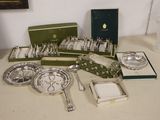 a lot of silverware on a table next to a glass