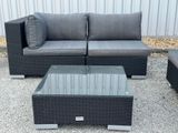 a couch and a coffee table on the gravel