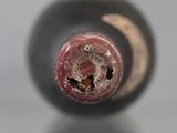 a close up of a wine bottle with a hole in it