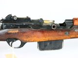 an old rifle with a wooden barrel and a metal muzzle