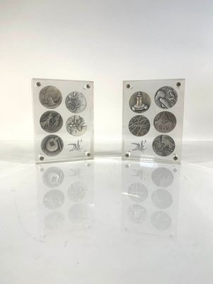 two clear acrylic boxes with different types of coins on them