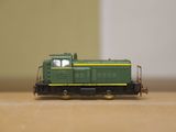 a toy train on a table with a wall in the background