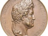 une image représentant une médaille de bronze sur laquelle figure la tête d'un homme
