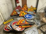 a lot of road signs that are sitting on the floor