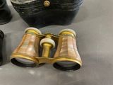 a black purse and a pair of binoculars sitting on a table