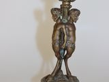 un vase en bronze posé sur un socle orné de deux chérubins