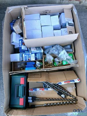 une boîte remplie d'objets hétéroclites posée sur le sol