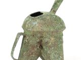 roman bronze helmet shaped vase with a handle on a white background