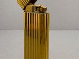 a gold lighter that is sitting on a table