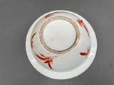 a white plate with a red design on it