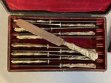 silverware in a red box with a knife and other silverware in it