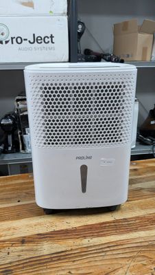 a small air purifier sitting on a wooden table