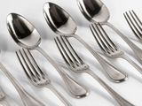 six forks and six spoons on a white table