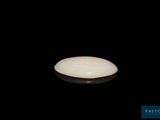 a white frisbee that is sitting on a black surface