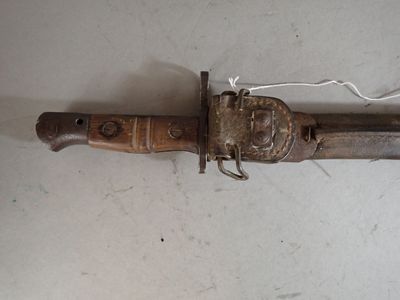 a very old knife that is laying on the floor