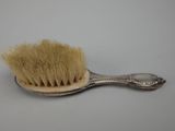 a brush that is sitting on top of a spoon