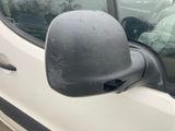 a side view mirror of a white car with a dog in the back seat