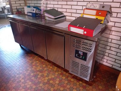 a metal counter with a bunch of files on top of it