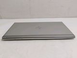 the laptop is sitting on a white surface with a white background