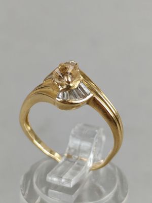 a close up of a gold ring with a diamond on top of it