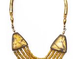a close up of a necklace on a white background