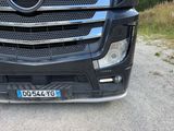 a close up of a black truck parked on the side of the road