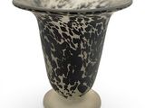 a black and white vase sitting on top of a table