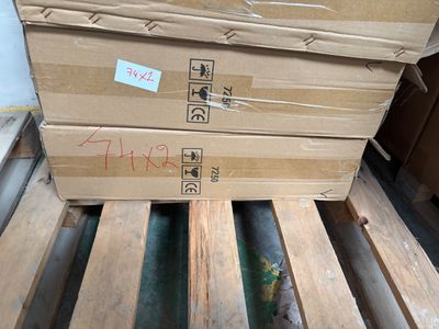 a stack of boxes sitting on top of a wooden pallet