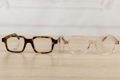 two pairs of glasses sitting on top of a wooden table