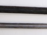 two knives that are on a white surface
