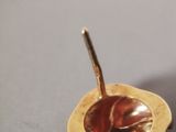 a spoon that is sitting in a bowl on a table