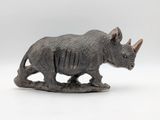 statue of a rhino on a white background with a white background